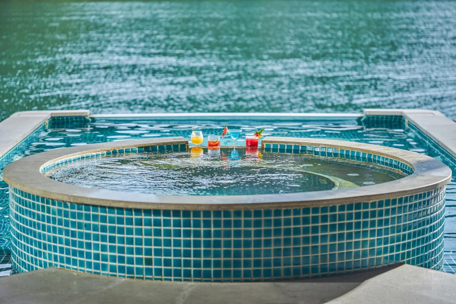 Jacuzzi on deck with drinks, facing the bay