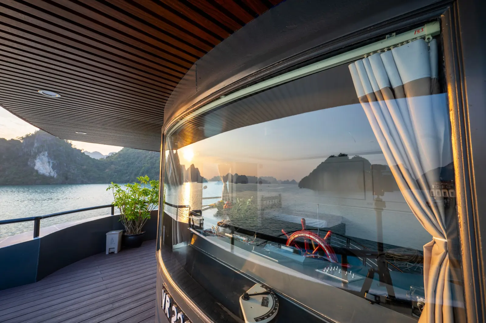 Captain's deck with the ship's wheel and bay view