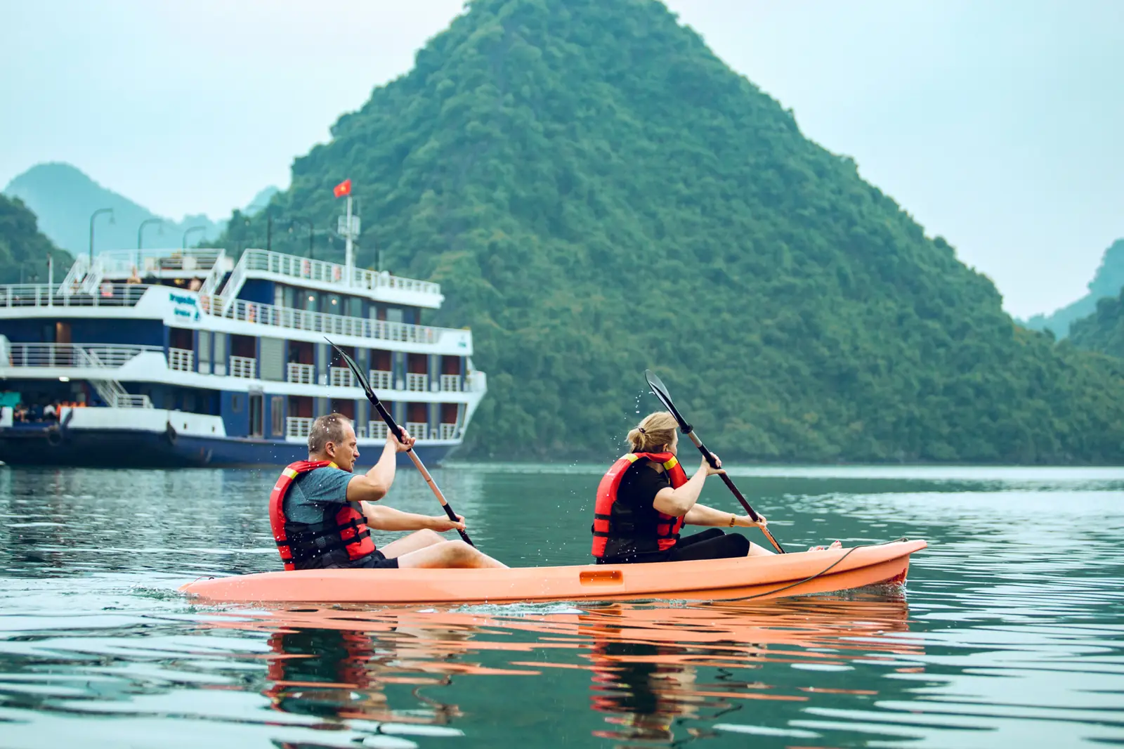 Kayaking on the bay with the ship behind