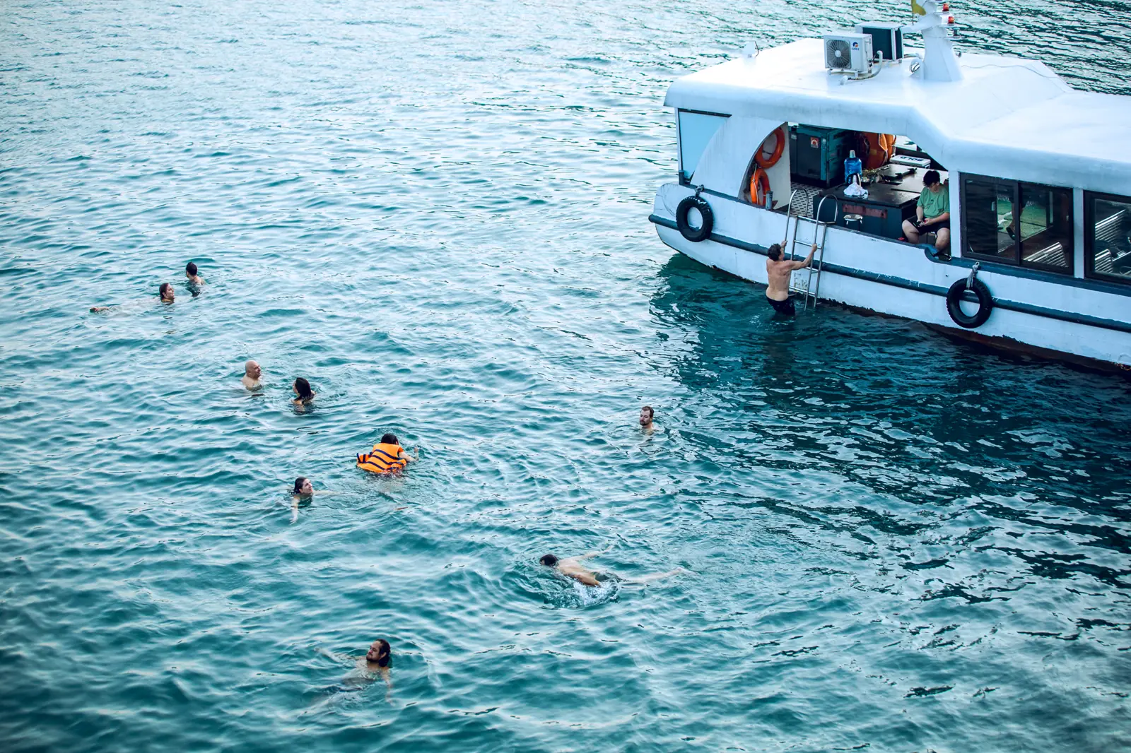 Guests swimming off the ship's tender