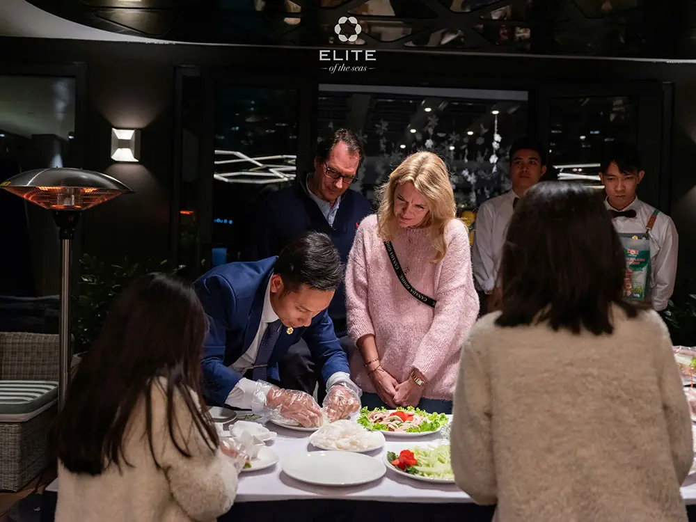Guests making spring rolls in the cooking demonstration