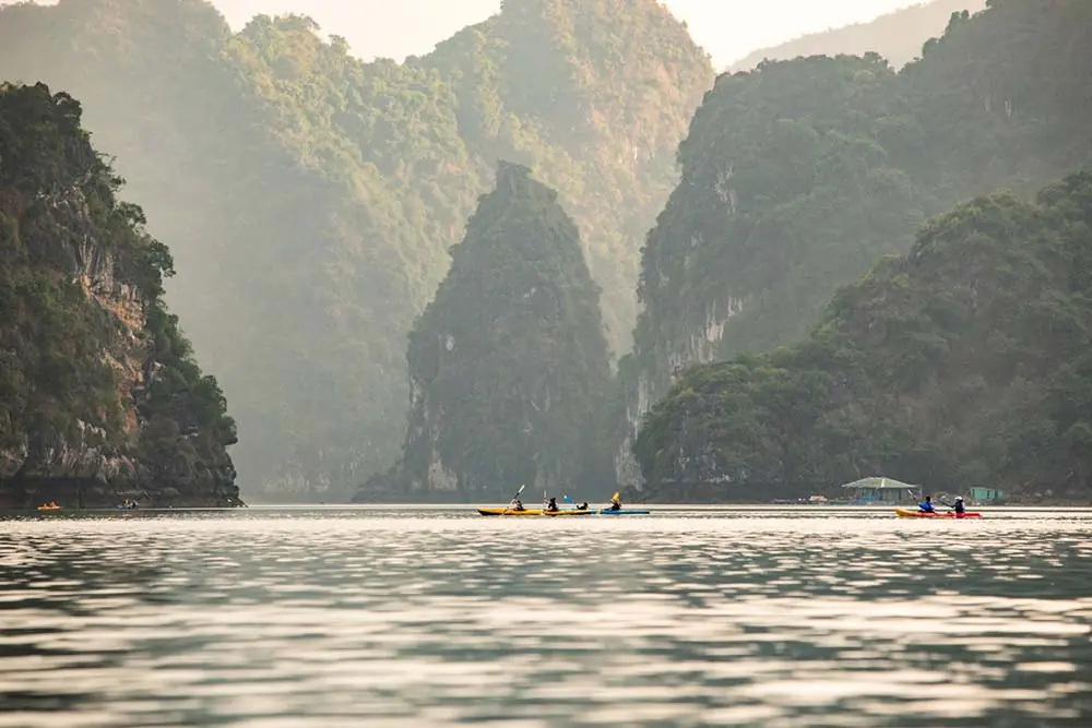 Kayaks on calm water between tall karsts