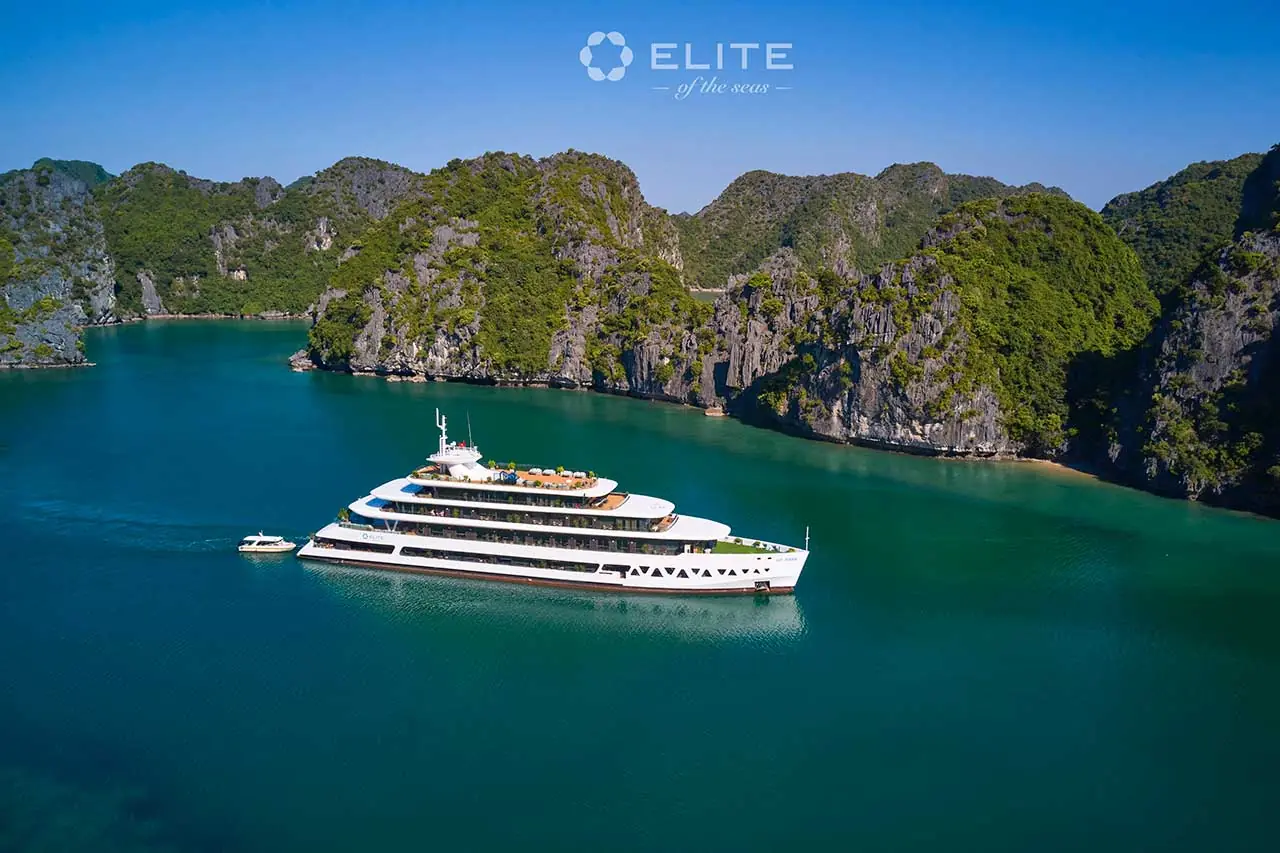 Elite of the Seas sailing past green limestone islands