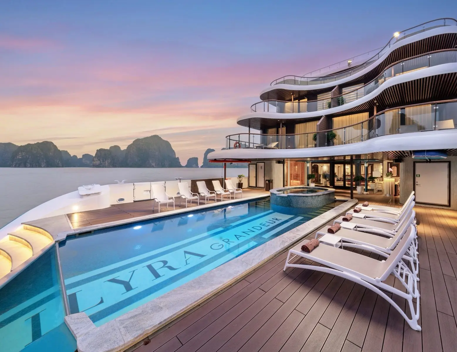 Heated pool and sun loungers at the stern of Lyra Grandeur at sunset