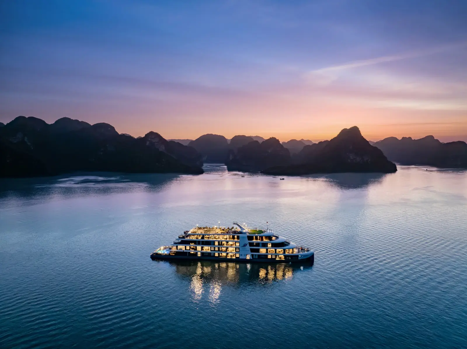 Lyra Grandeur lit up at blue hour on the calm bay
