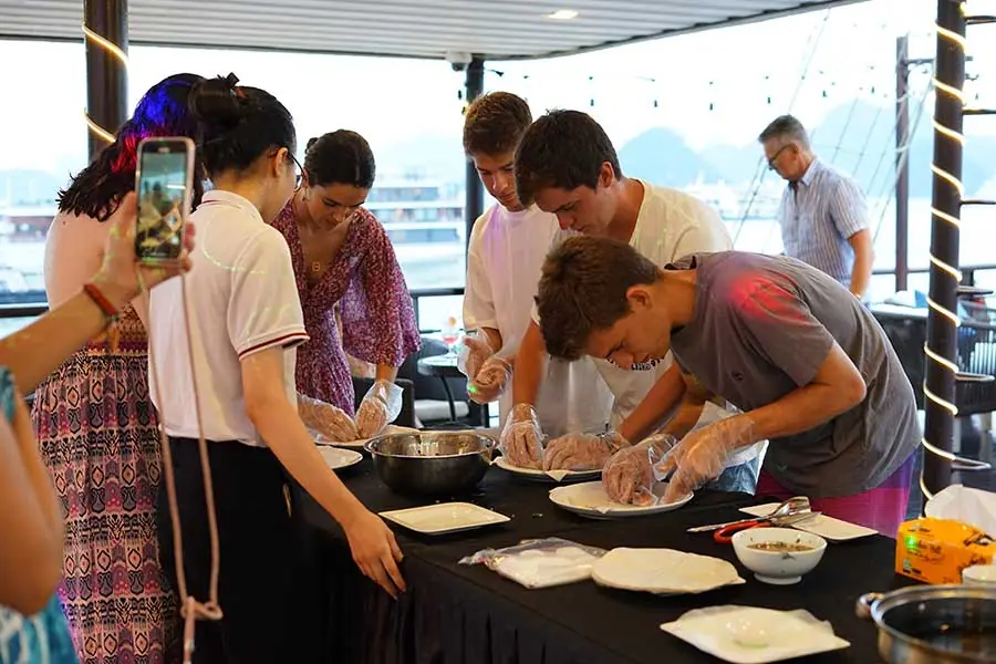 Guests making spring rolls in the cooking class