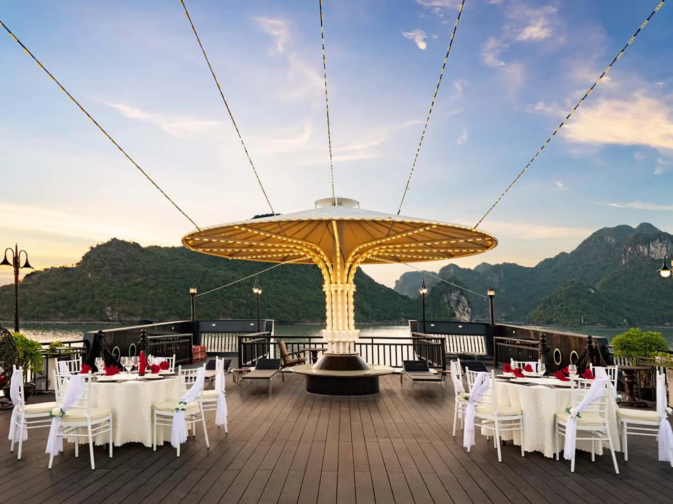 Tables laid on deck for a party at sunset