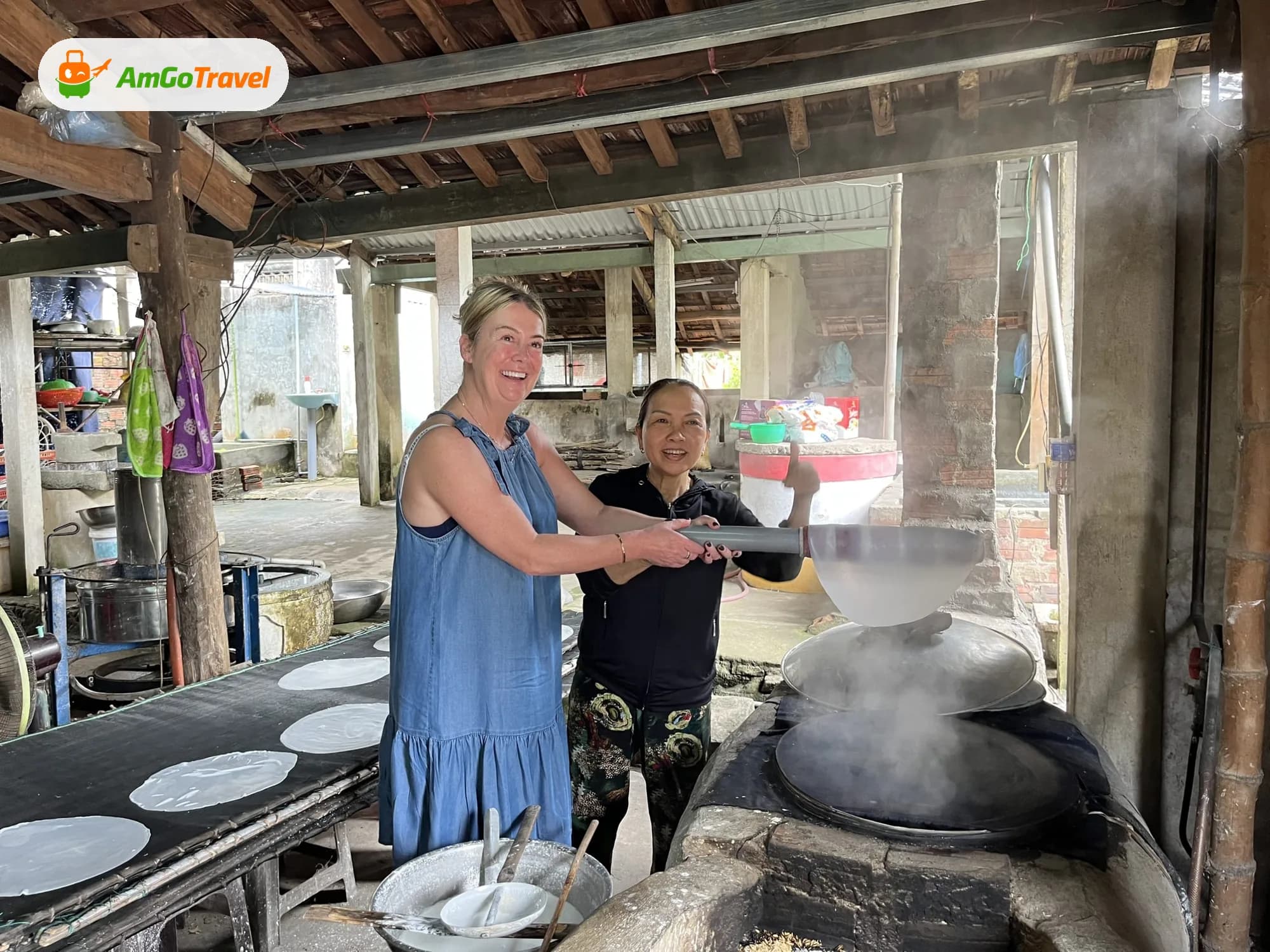 Traveller making rice paper over a steaming wood stove