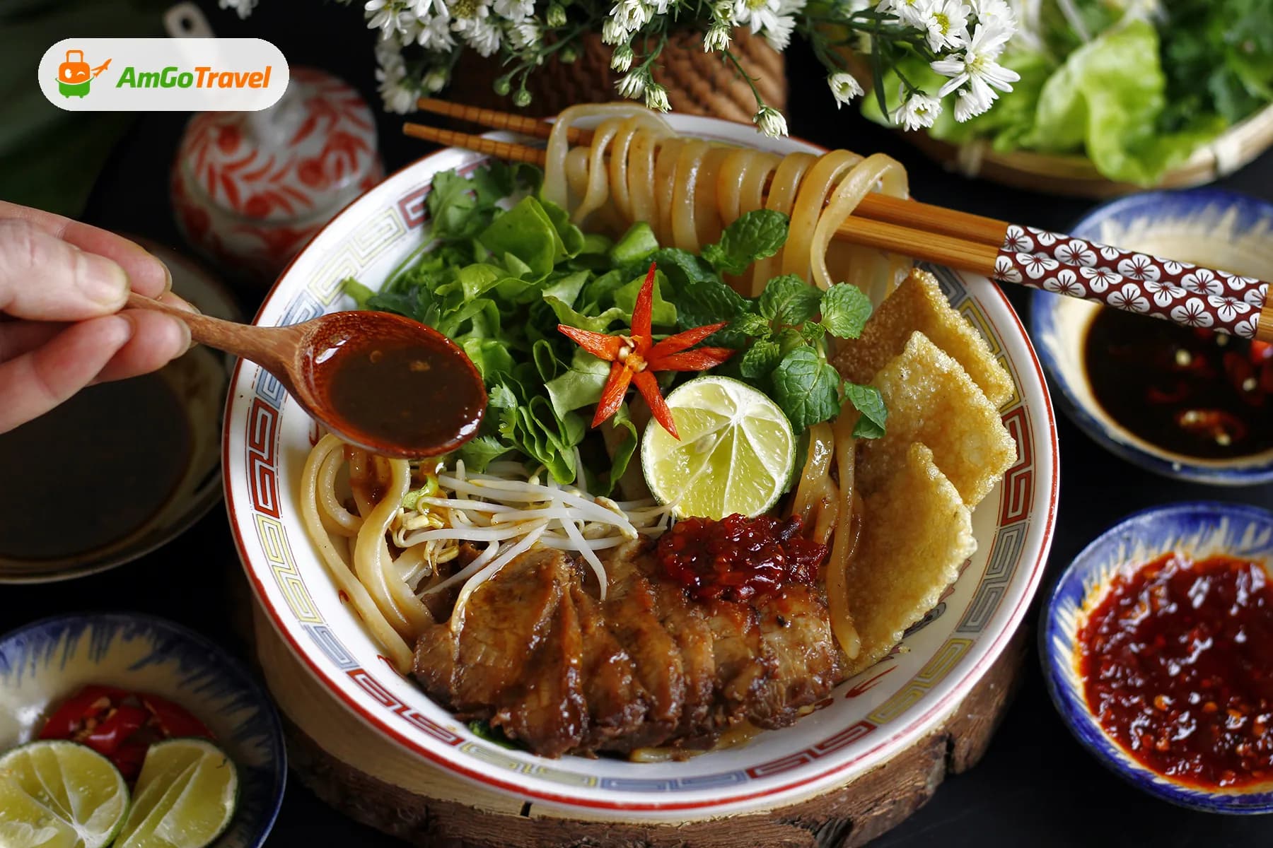 Bowl of Vietnamese noodles with herbs and dipping sauces