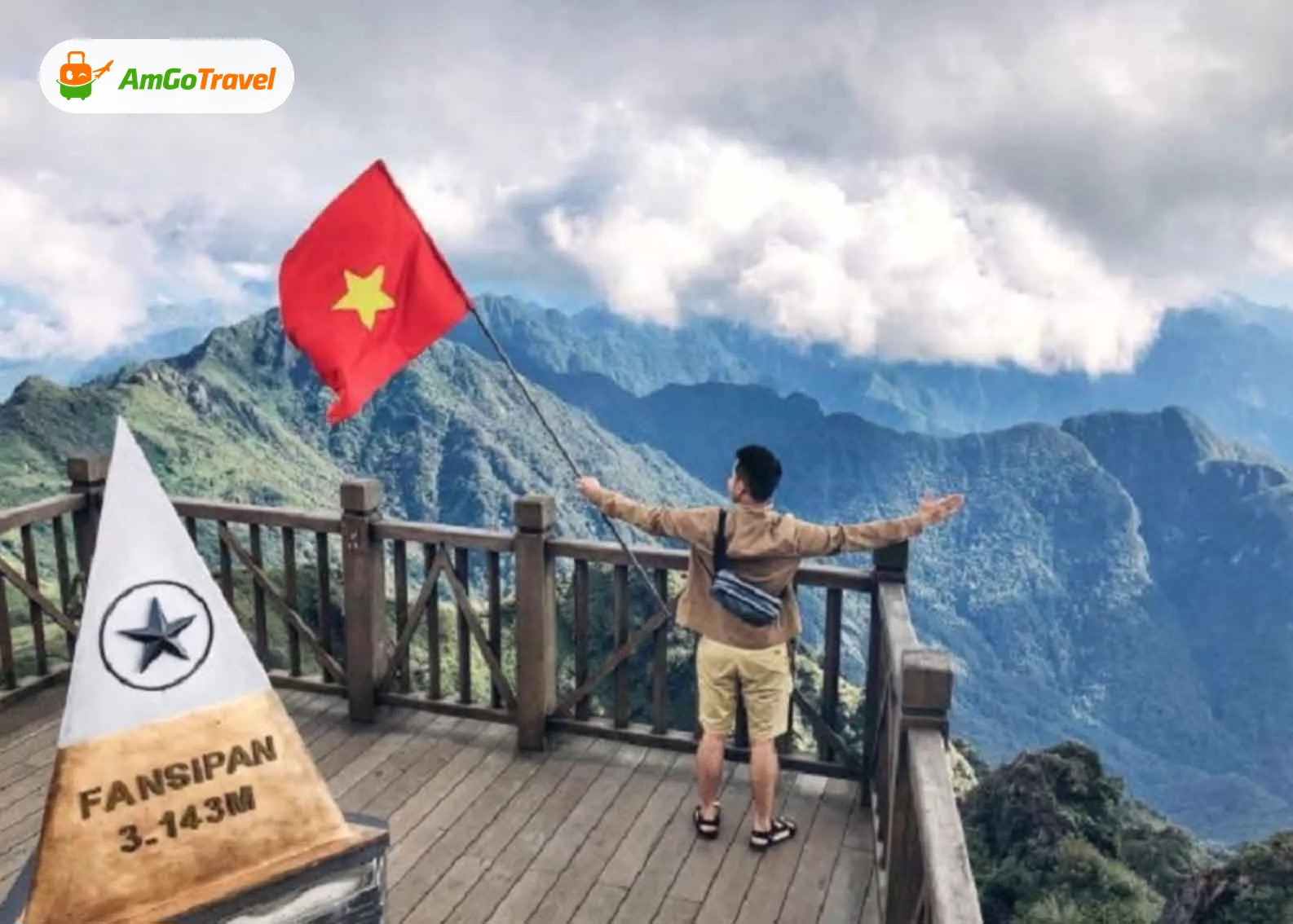 Man with arms open beside Fansipan summit marker