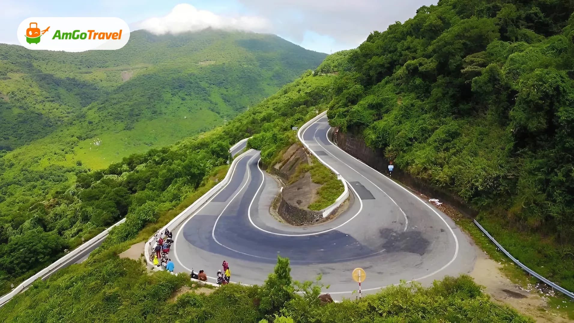 Winding road on Hai Van Pass through green hills