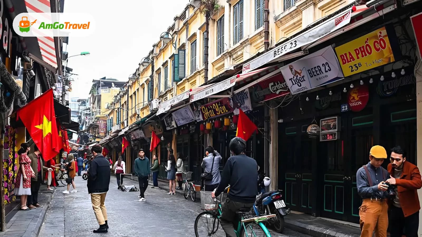Hanoi Old Quarter street with yellow facades and flags
