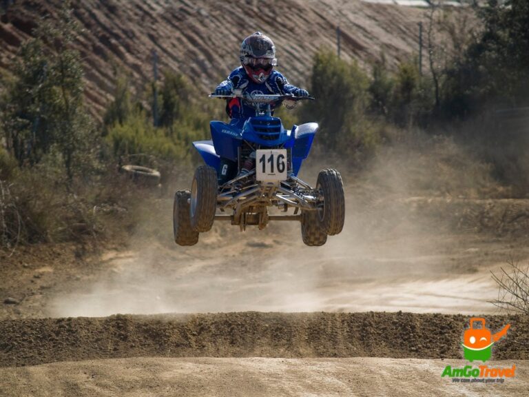 Quad bikes kicking up dust on an off-road track