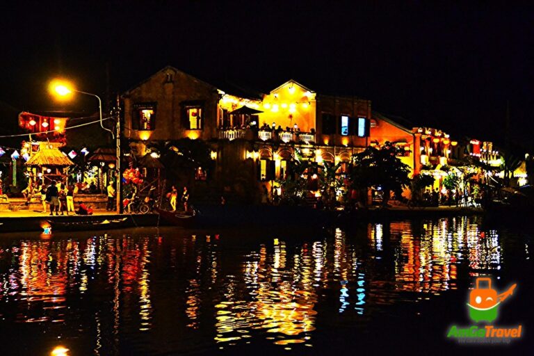 Hoi An coconut jungle tour: Hoi An riverfront reflected in the river at night