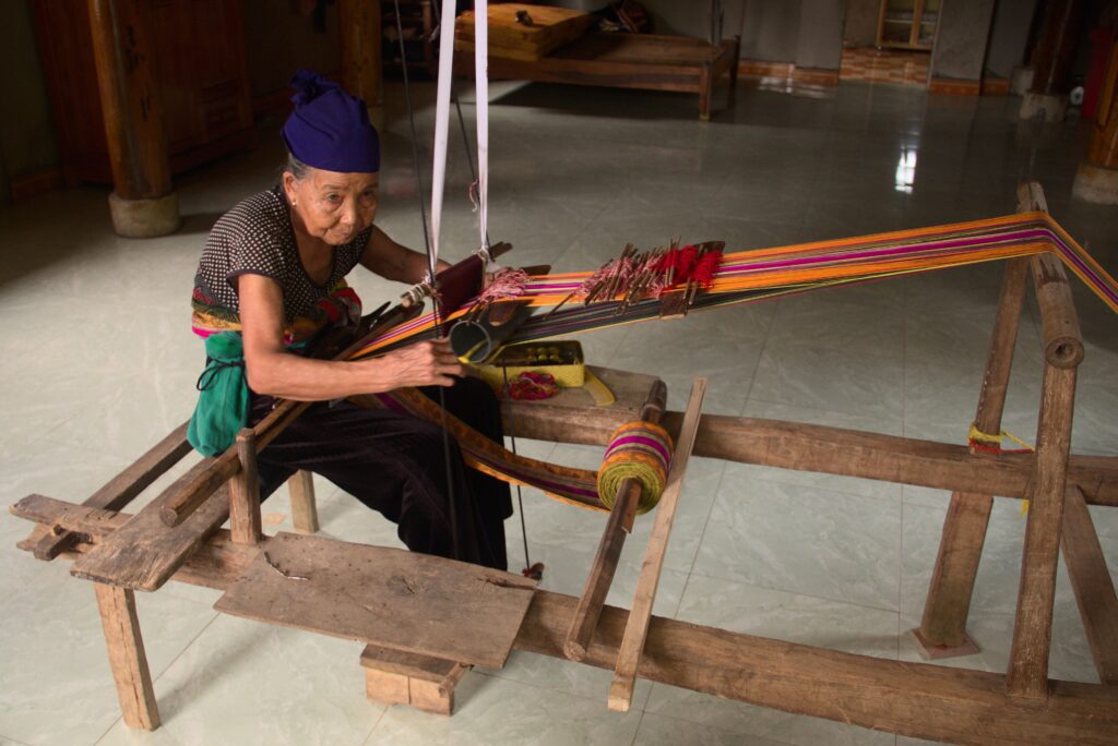Traditional brocade weaving on a loom in Pu Luong