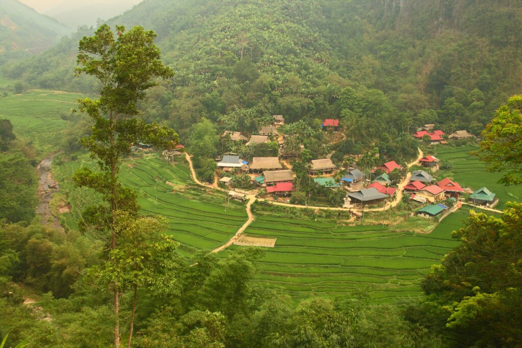 A village among rice fields in the Pu Luong valley