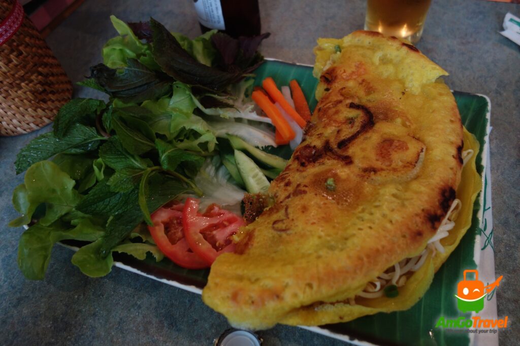 Vietnamese pancake (banh xeo) with fresh herbs