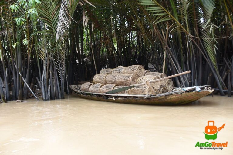Tra Nhieu cooking class: Fishing boat among water palms on a Quang Nam river
